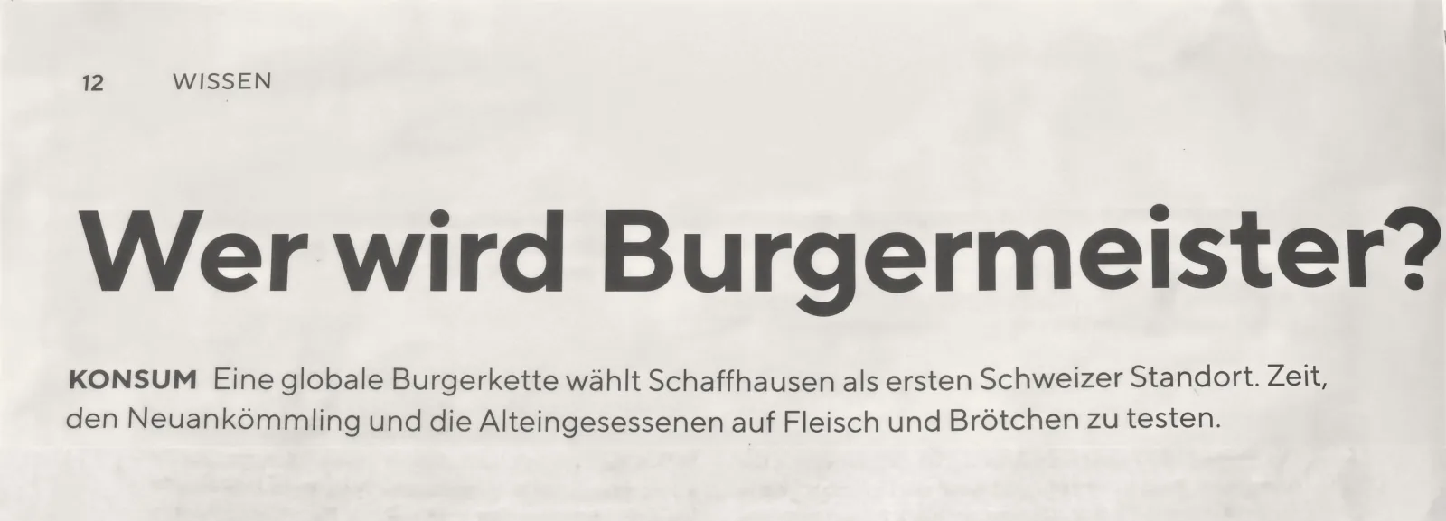 Zeitungsausschnitt der Schaffhauser AZ, Seite 12, Rubrik Wissen: Titel «Wer wird Burgermeister?», darunter: «Eine globale Burgerkette wählt Schaffhausen als ersten Schweizer Standort. Zeit, den Neuankömmling und die Alteingesessenen auf Fleisch und Brötchen zu testen.»